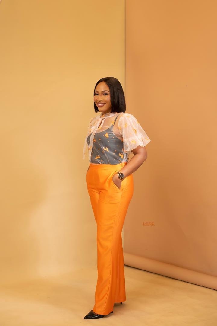 Ijeoma Faith Eze standing confidently in an orange ensemble